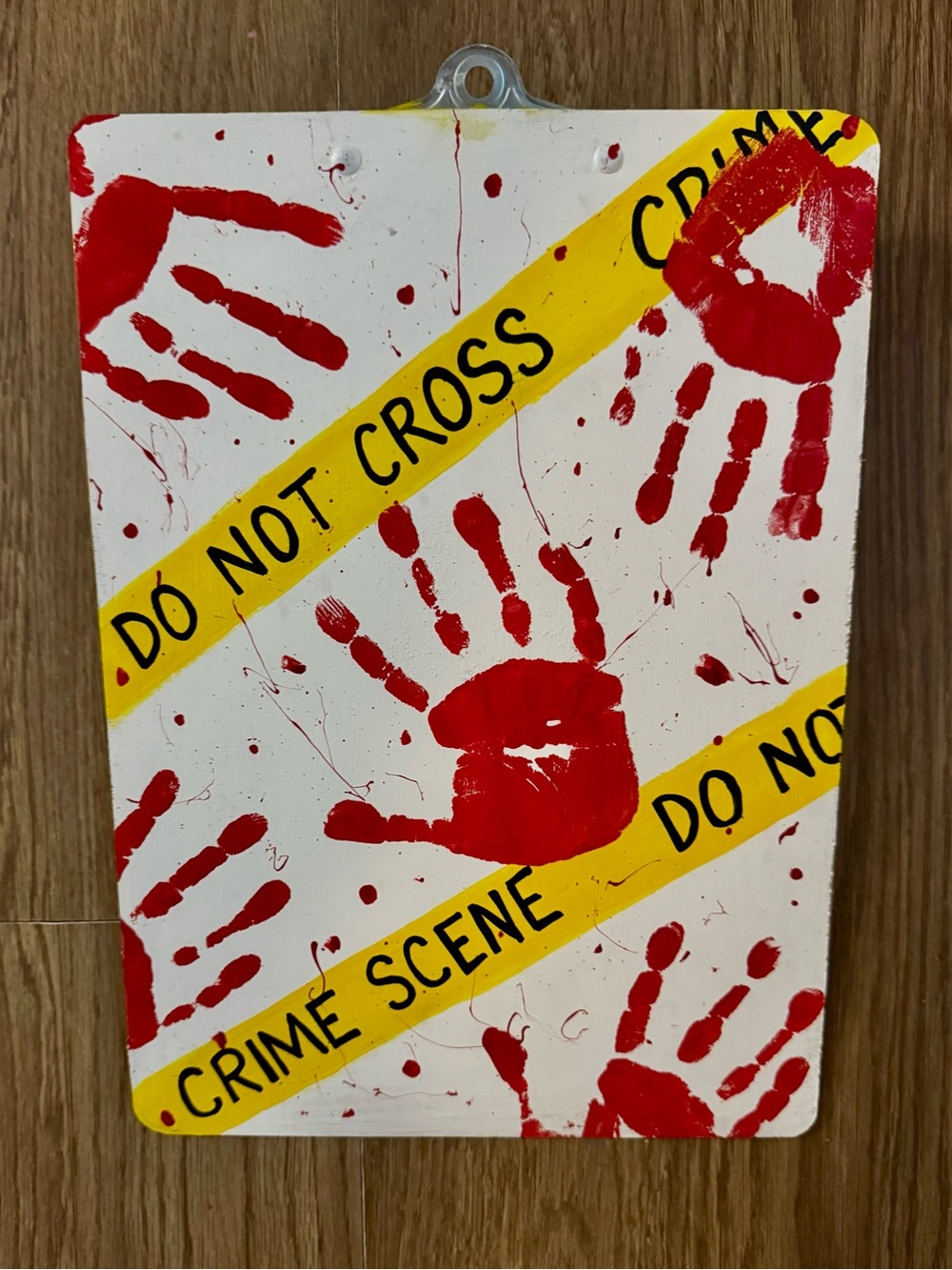 Hand Painted Crime Scene Handprint Clipboard with Red Handprints and Yellow Tape
